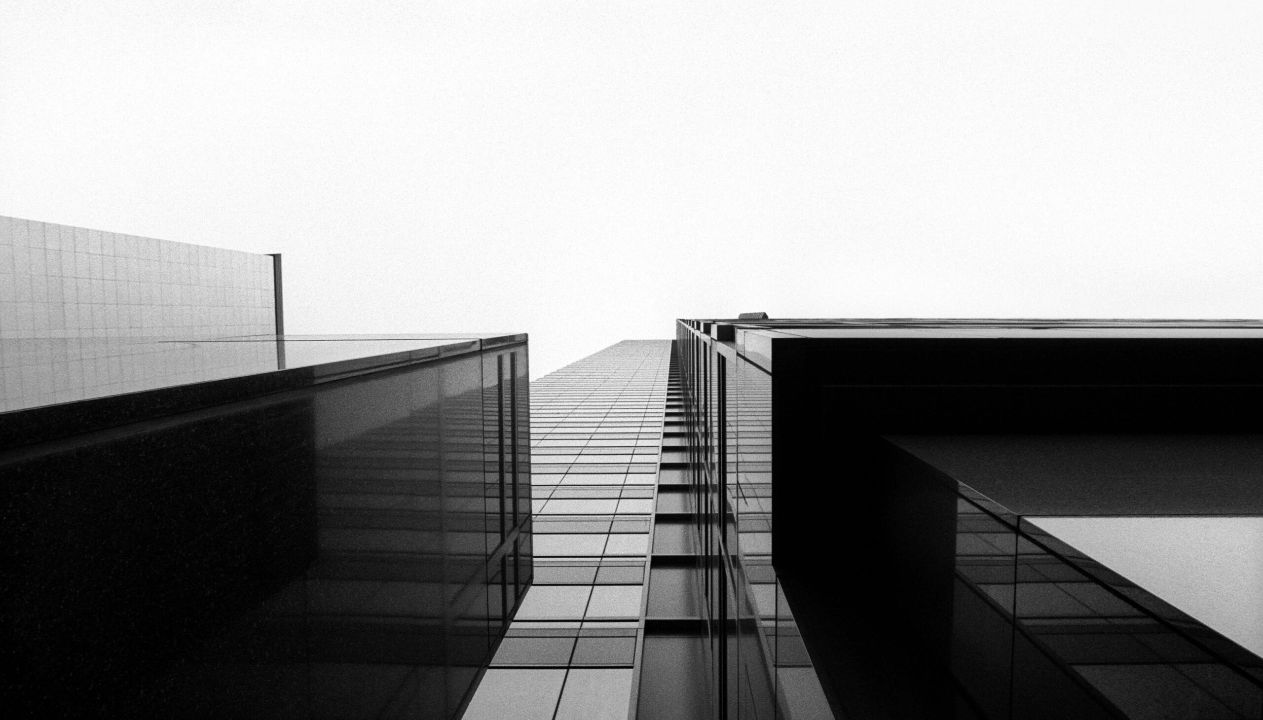 Black and white decorative photo of buildings from a ground perspective.